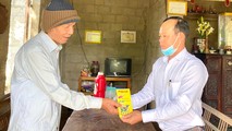 Nhà báo Nguyễn Quang Tám, Trưởng VPĐD Báo PLVN khu vực Bình Trị Thiên trao quà Tết cho người dân nghèo Thừa Thiên - Huế.