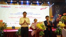 Mẹ Việt Nam anh hùng Nguyễn Thị Lan (ở giữa) nhận hoa và sổ tiết kiệm do Báo Pháp luật Việt Nam trao tặng.