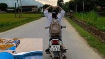 Hình ảnh một nữ sinh trên địa bàn huyện Yên Bình đi xe máy không đội mũ bảo hiểm, buông 2 tay để lên đầu