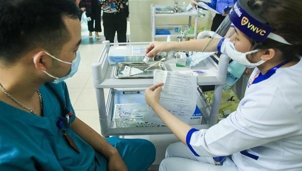 Kiểm tra thông tin trước khi tiêm. Ảnh: VGP/Thiện Tâm