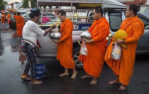 Một Phật tử biếu đồ ăn cho các nhà sư ở Bangkok