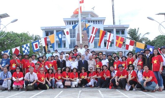 Đoàn kiều bào chụp ảnh lưu niệm bên cột mốc chủ quyền tại đảo Song Tử Tây