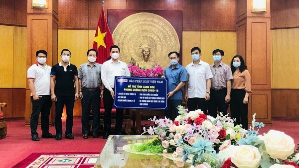 Nhà báo Vũ Đình Tiến – Trưởng văn phòng đại diện Báo Pháp luật Việt Nam khu vực phía Bắc thay mặt cho TS. Đào Văn Hội - Tổng Biên tập Báo Pháp luật Việt Nam và các nhà hảo tâm trao tặng quà cho tỉnh Lạng Sơn.