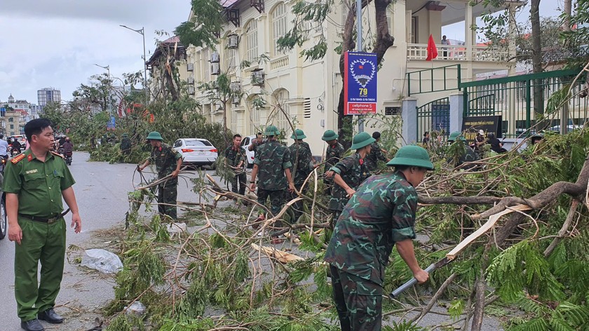 Lực lượng công an và quân đội phối hợp chặt chẽ trong việc thu dọn cây gãy, cành đổ.