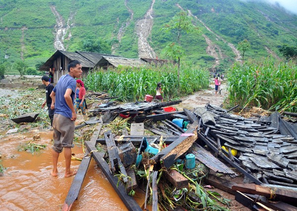 Người dân Quản Bạ (Hà Giang) ngậm ngùi nhìn ngôi nhà chỉ còn lại đống gỗ ngổn ngang. Ảnh: Báo Hà Giang