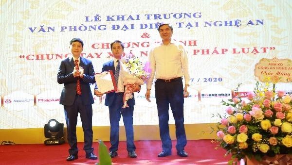 Ông Trần Đức Vinh, Phó Tổng Biên tập Báo PLVN (ngoài cùng bên trái) trao Quyết định Trưởng VPĐD Báo tại Nghệ An và ông Hoàng Nghĩa Hiếu, Phó Chủ tịch UBND tỉnh Nghệ An tặng hoa chúc mừng nhà báo Ngô Văn Toàn.