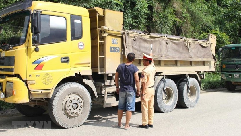 Cảnh sát giao thông kiểm tra một xe tải lưu thông trên đường. Ảnh minh họa. (Nguồn: TTXVN).