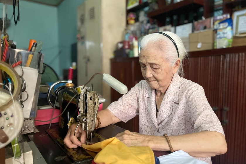 Mỗi ngày, má Ba vẫn miệt mài may quần áo để tặng người nghèo.